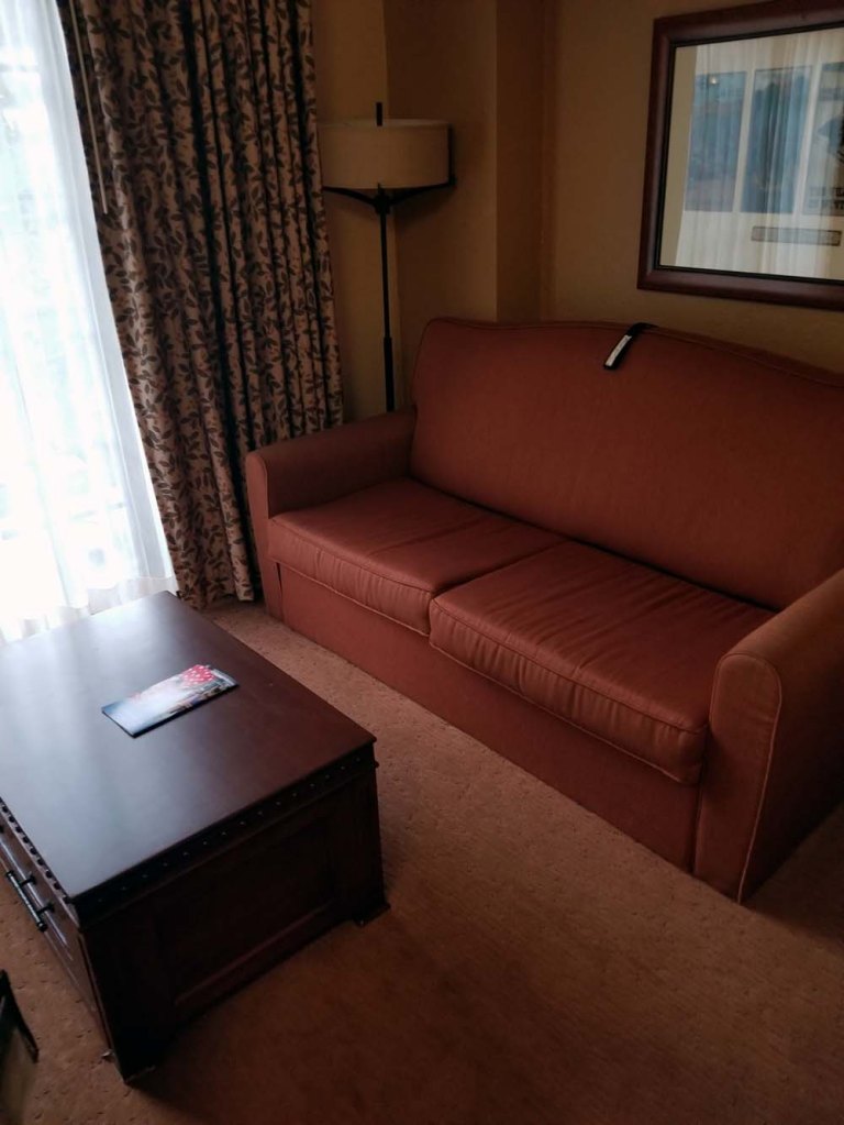 Deluxe Studio at Boulder Ridge Villas. Red couch and coffee table