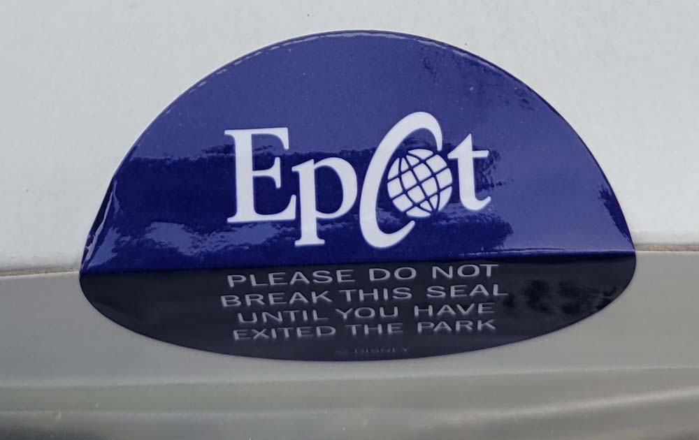 close up of consumption warning sticker "please do not break this seal until you have exited the park" EPCOT